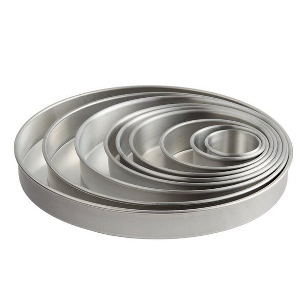 A set of six Choice round metal cake pans.