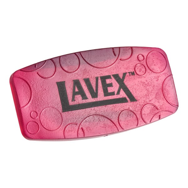 A pink Lavex toilet bowl clip with a green apple scent.