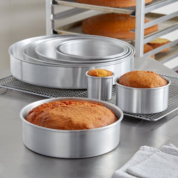 A group of round metal pans with baked food in them.