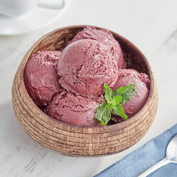 A bowl of Pitaya Foods acai sorbet with berries and mint.