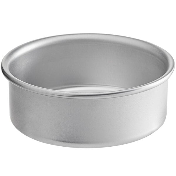 A silver round mini cake pan with straight sides.