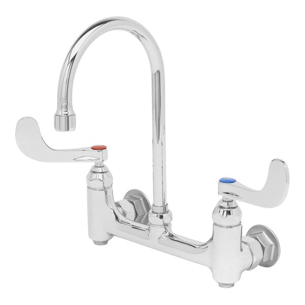 A silver T&S wall mounted surgical sink faucet with 4" wrist action handles.