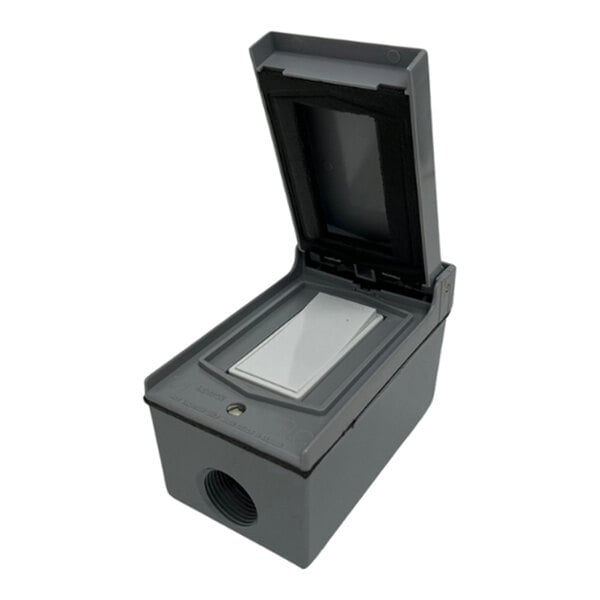 A white rectangular object with a black plastic lid and a small black box inside.