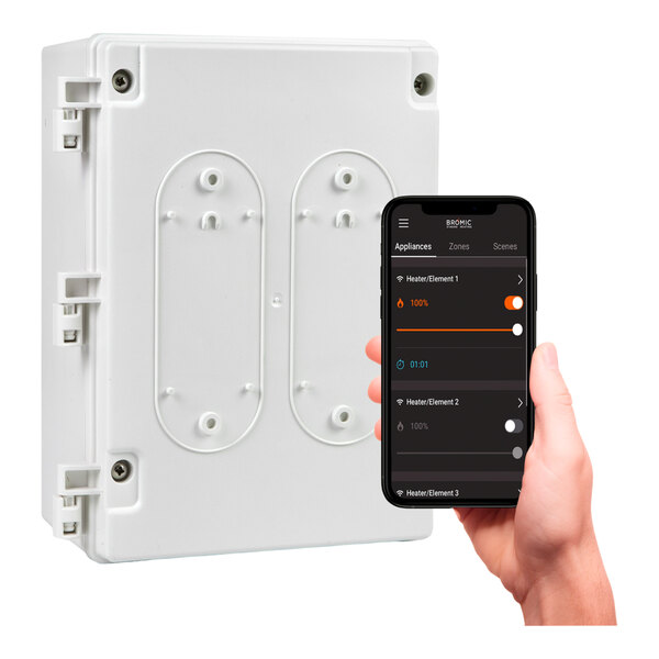 A hand holding a cell phone with a screen showing the Bromic Heating smart box.