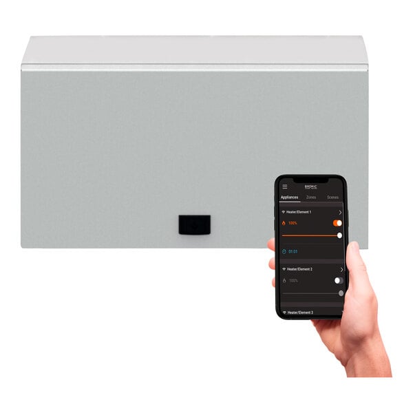 A person holding a cell phone with a screen showing Bromic Heating 5 Channel On / Off Controller options.
