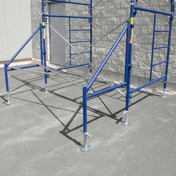 A solid galvanized steel adjustable leveling jack with a base plate attached to blue scaffolding.