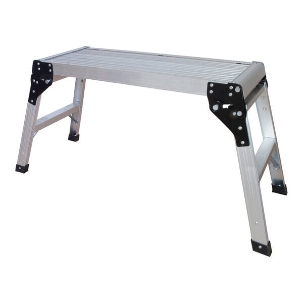 A portable aluminum work platform with four foldable legs and a ribbed surface.
