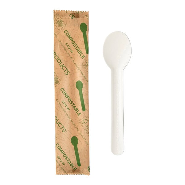 A white cylindrical package with a green and white wrapper and a white molded paper spoon inside.