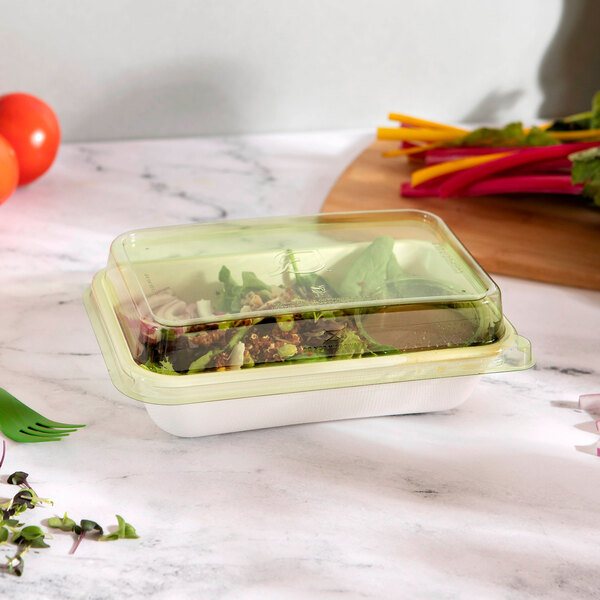 A rectangular Eco-Products WorldView compostable plastic dome lid on a container of food.