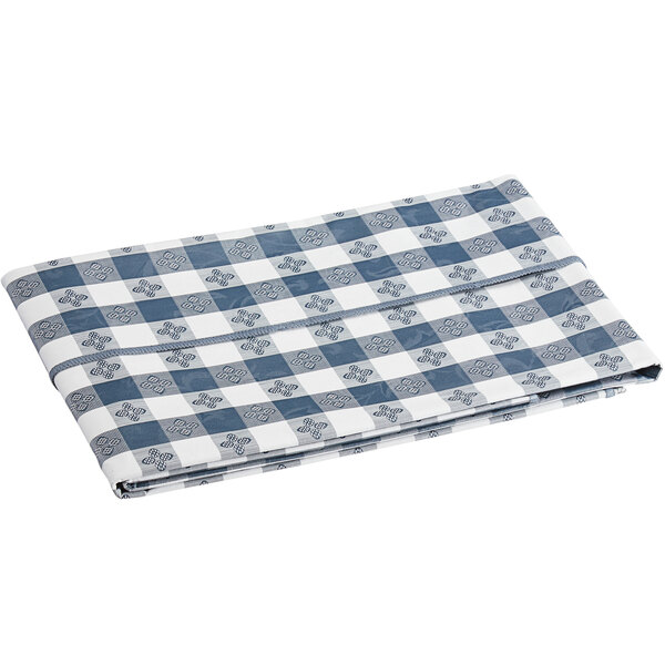 A folded navy and white gingham vinyl table cover with a flannel back.