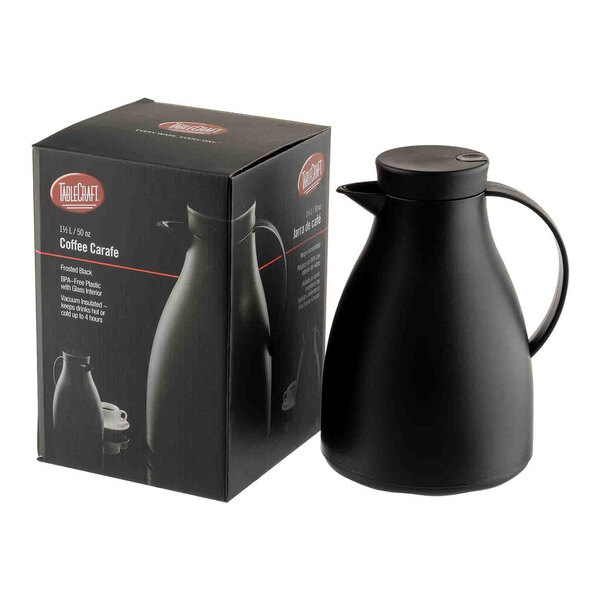 A black plastic coffee carafe with a glass liner, shown next to its packaging box.