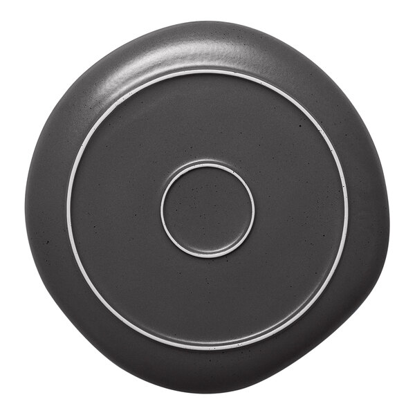 A grey porcelain plate with black dots surrounding a white circle.