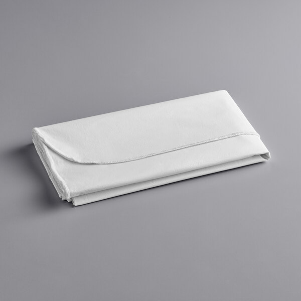 A folded white vinyl table cover with a flannel back.