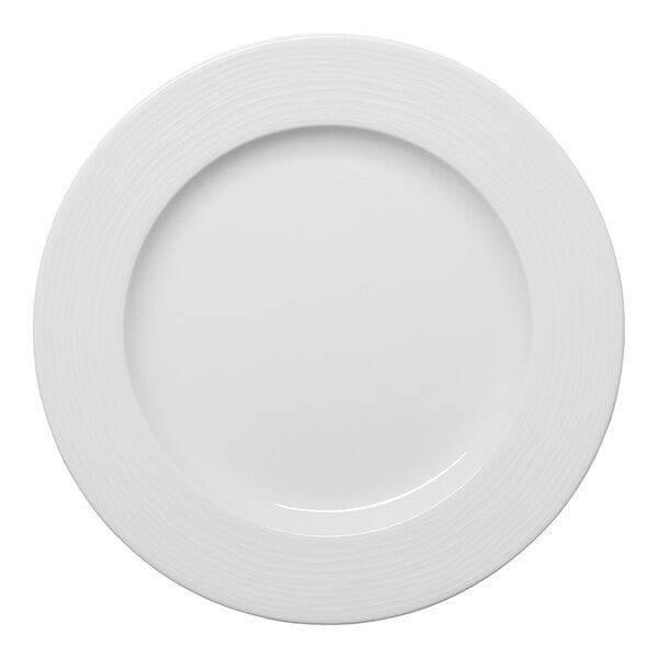 A white round porcelain plate with an embossed wide rim.