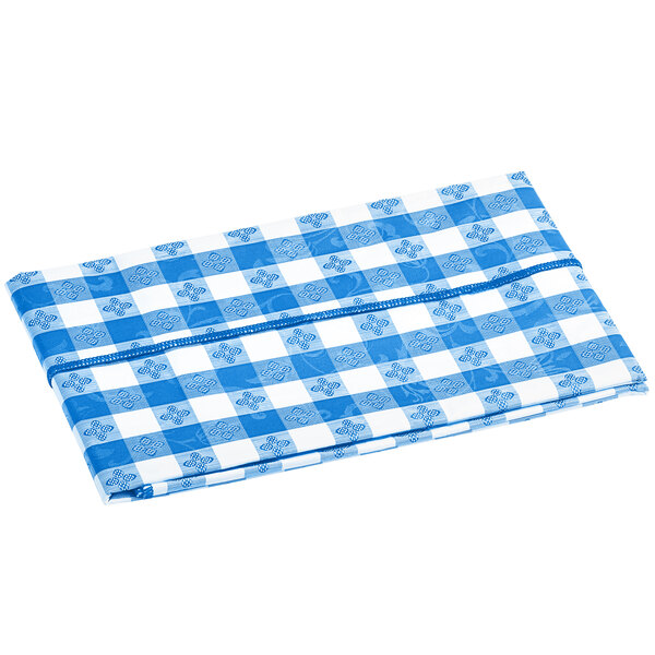 A folded royal blue and white gingham vinyl table cover with a flannel back.