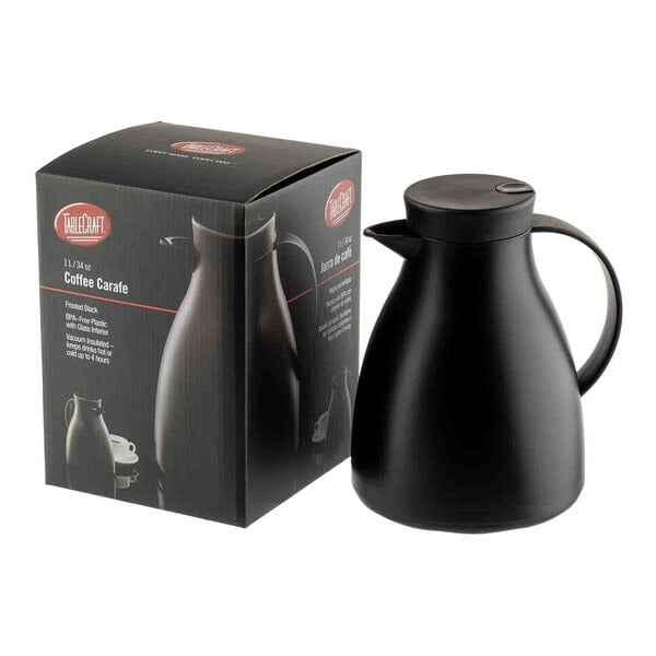 A black plastic coffee carafe with a glass liner, shown next to its packaging box.