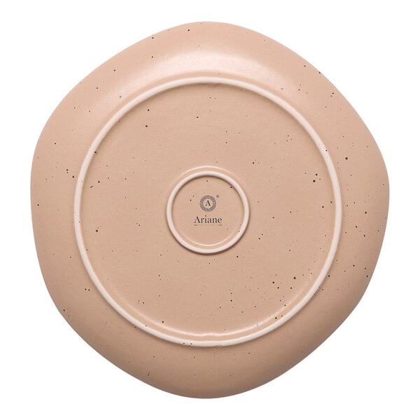 A dark sand porcelain plate with white circular dots on it.