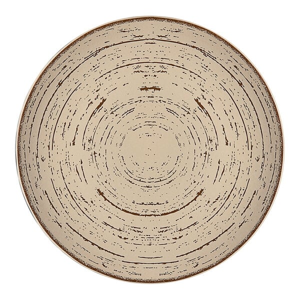 An Ariane Tornado round porcelain plate with a circular sand dollar pattern.