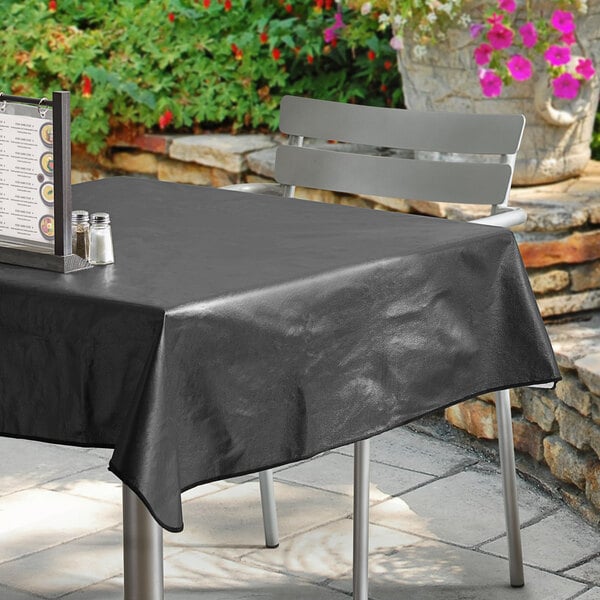 A square black vinyl table cover with a flannel back, draped over a patio table.