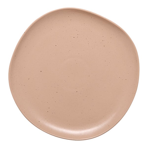 A close-up of an Ariane Earth dark sand porcelain plate with small speckled dots.