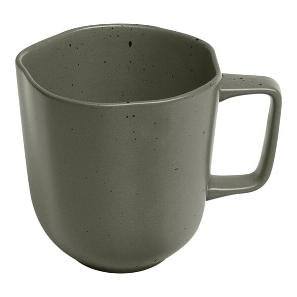 An Ariane mist green porcelain mug with grey dots and a handle.