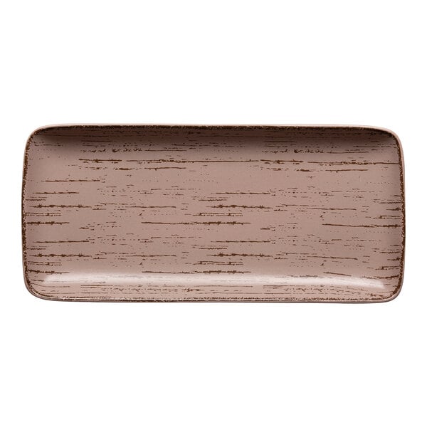A close-up of a rectangular Ariane Dessert Sage porcelain plate with a pattern on it.