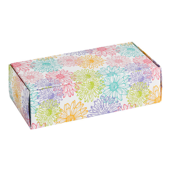 A rectangular candy box with a colorful floral pattern.