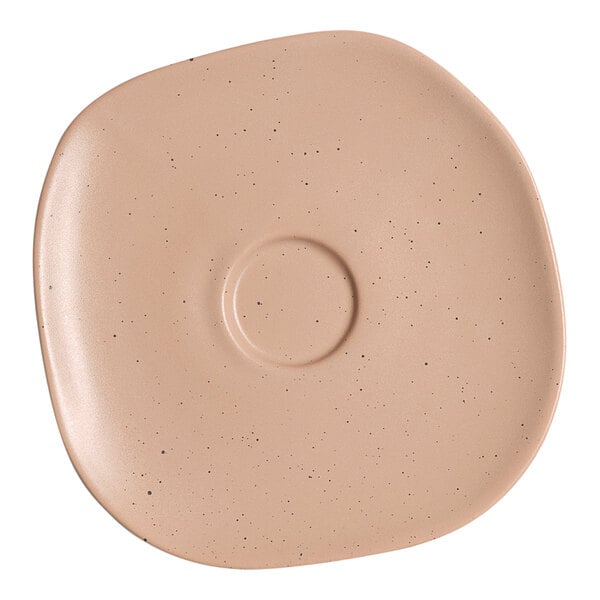 An Ariane Earth porcelain saucer with a brown speckled design.