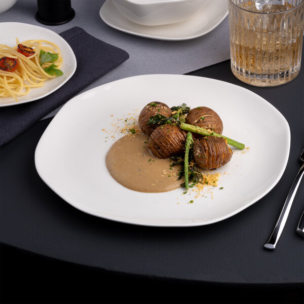 A plate of food on a table with a glass of wine.