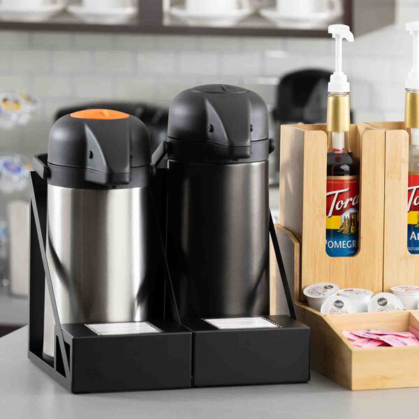 A black powder-coated stainless steel airpot rack with a drip tray holding two airpots.