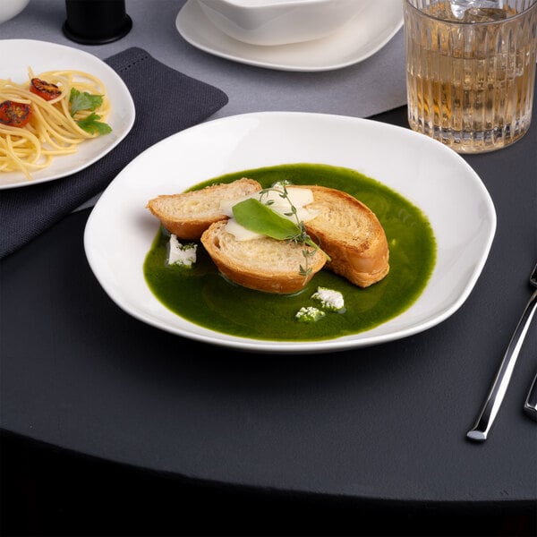 An Ariane Earth porcelain plate with food on a table.