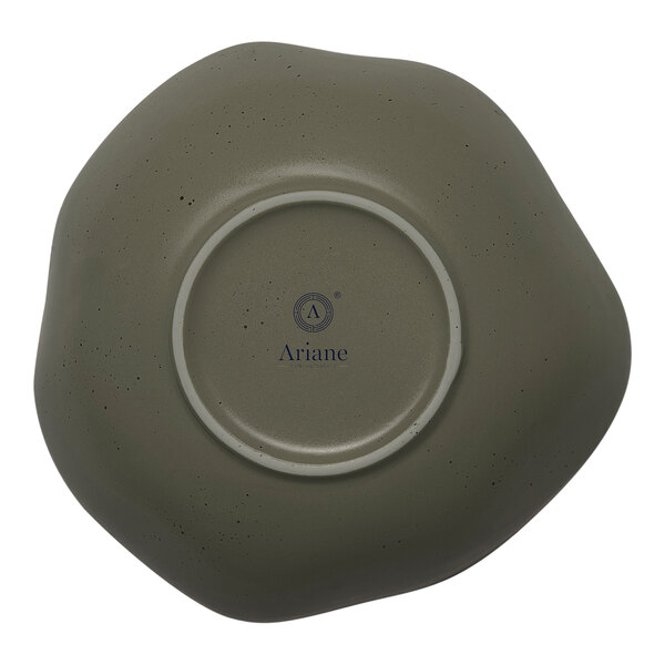 A mist green porcelain bowl with white dots on the inside.