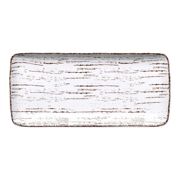 A rectangular white porcelain plate with brown trim.