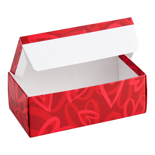 A red rectangular candy box with a modern heart pattern and an open lid.