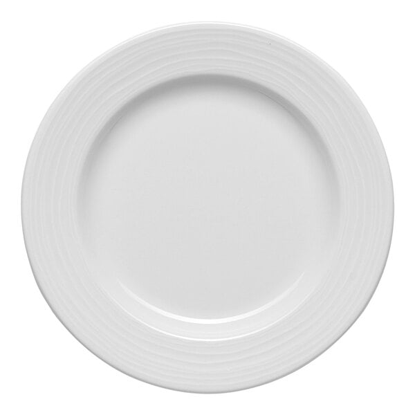 A white round porcelain plate with an embossed wide rim.