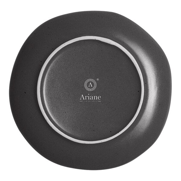 A black porcelain plate with white dots around the border.