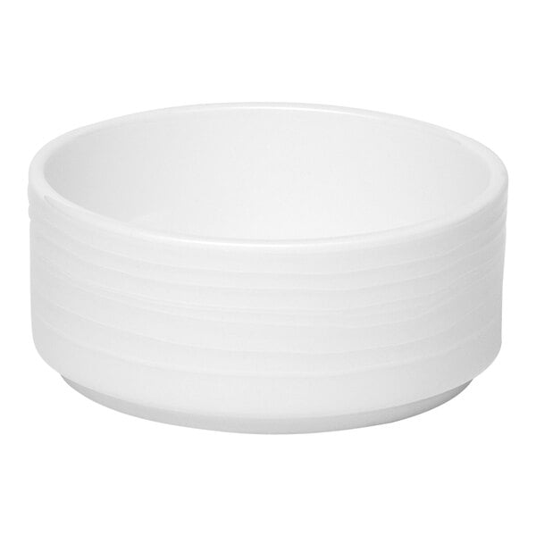 A small white embossed porcelain butter ramekin.