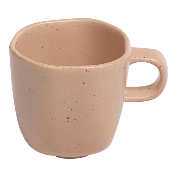 An Ariane dark sand porcelain espresso cup with speckled design.
