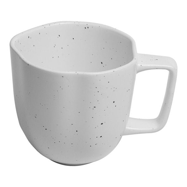 A white porcelain mug with speckled dots.