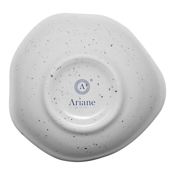 A white porcelain bowl with black speckled spots and the text "Ariane Earth" in blue.