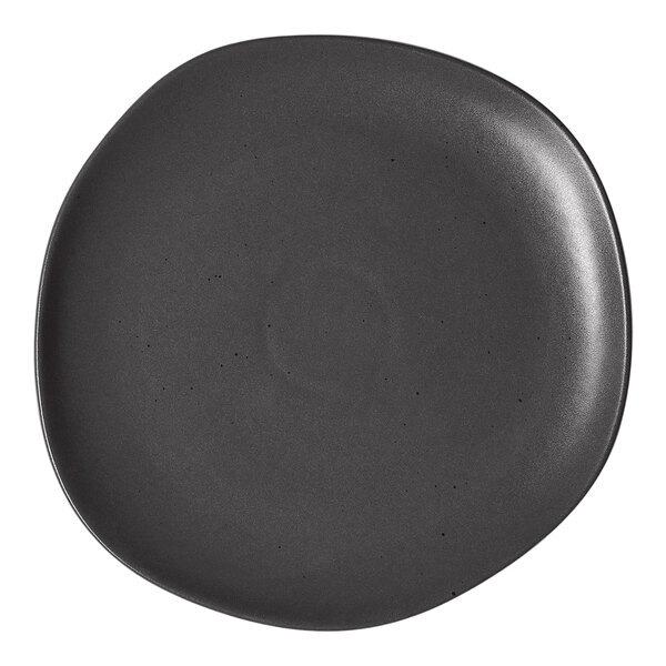 An Ariane Earth charcoal grey porcelain plate with circular dots.