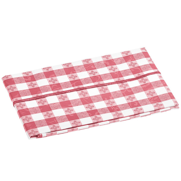 A folded burgundy and white gingham vinyl table cover with a flannel backing.