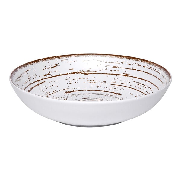 An Ariane Tornado white porcelain plate with brown specks.