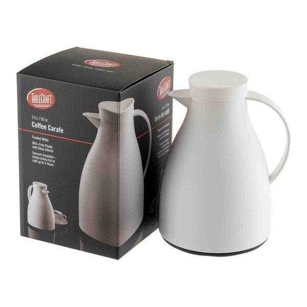 A white plastic coffee carafe with a glass liner, shown next to its packaging box.