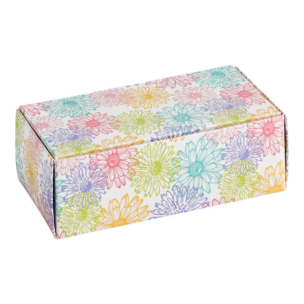 A rectangular cardboard candy box with a colorful floral pattern.