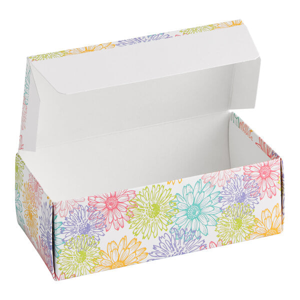 A rectangular cardboard candy box with a hinged lid, decorated with colorful spring flower patterns.