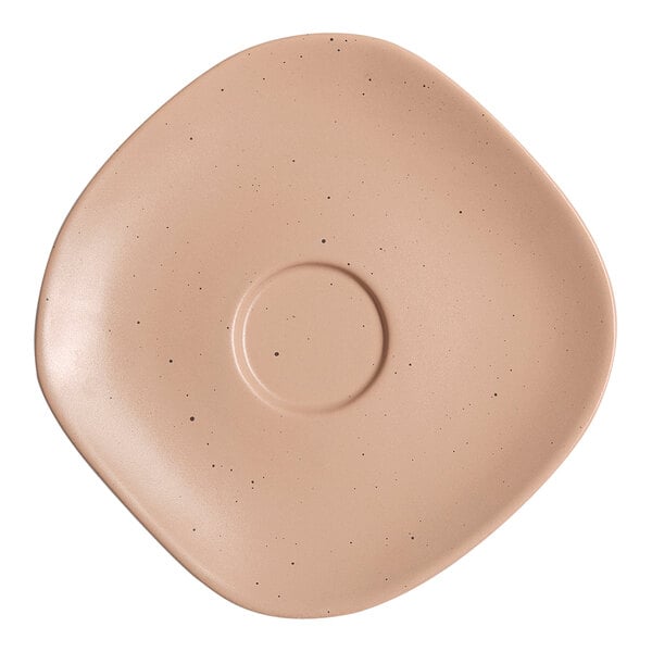 A dark sand porcelain saucer with black dots around the rim.