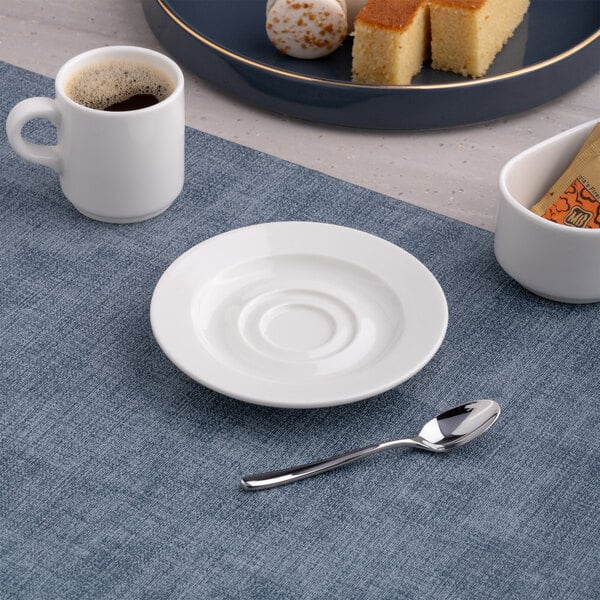 A round, warm white porcelain espresso cup saucer with a wide rim.
