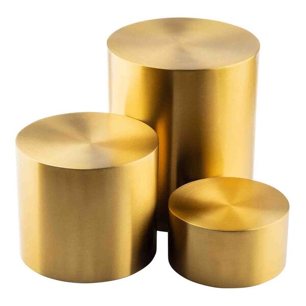 A set of three round gold stainless steel risers in varying heights.