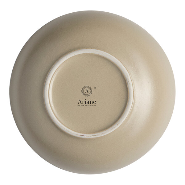 A white porcelain plate with a sand dollar design in the center.